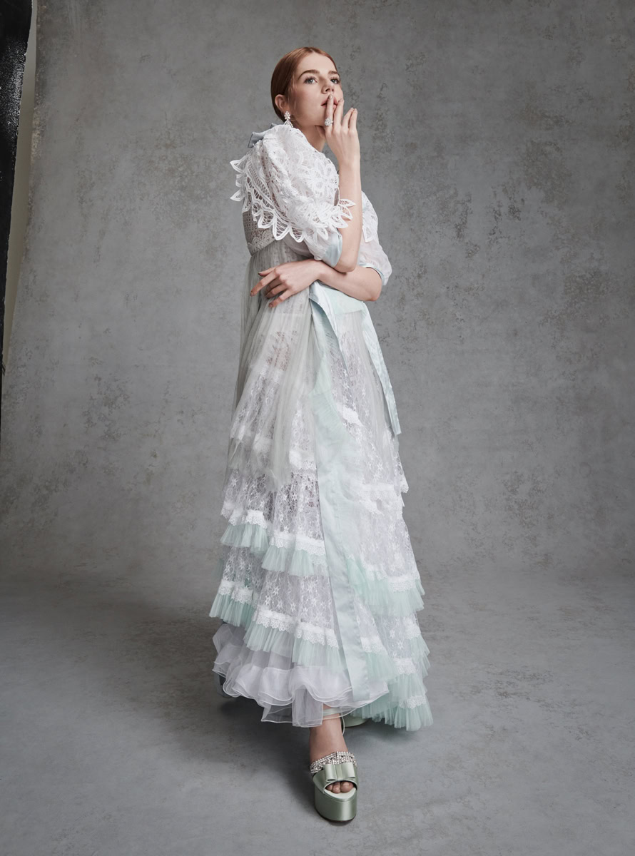 White vintage lace wedding dress with ruffled layers and pastel accents, styled by Pamela Hanson Photography.