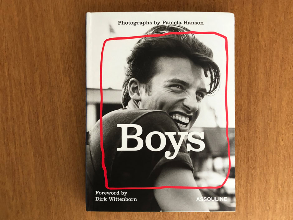 Young man smiling in black and white photo on the cover of the book "Boys" by Pamela Hanson, highlighting portrait photography and male subjects.